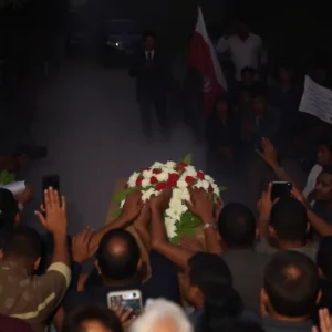 Chaotic scene at a funeral wake with police presence