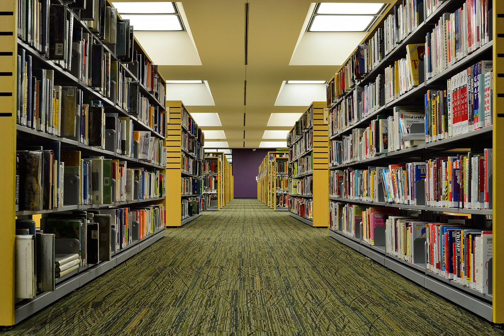 Library aisle lined with bookshelves
